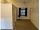 Bright living room with carpeted floor, curtains, and large wall at 4164 New Marsh Rd, Deland, FL 32724