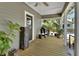 Inviting back porch with a Hello mat, grill and an antique-looking storage unit at 427 E Church St, Deland, FL 32724