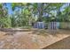 A spacious backyard featuring a storage shed and a chicken coop at 427 E Church St, Deland, FL 32724