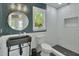Modern bathroom features a unique vessel sink, white subway tile shower, and stylish blue wallpaper at 427 E Church St, Deland, FL 32724