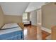 Bright bedroom with hardwood floors, two beds, and a window view, perfect for or guests at 427 E Church St, Deland, FL 32724