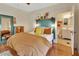 Comfortable bedroom featuring stylish decor, hardwood floors and easy access to a private bathroom at 427 E Church St, Deland, FL 32724