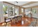 Bright dining room featuring hardwood floors, a modern light fixture, and a large window at 427 E Church St, Deland, FL 32724