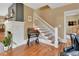 Welcoming entryway featuring hardwood floors, a fireplace, and a staircase with white railing at 427 E Church St, Deland, FL 32724