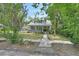 Charming home with a metal roof, cozy porch, and landscaped yard at 427 E Church St, Deland, FL 32724
