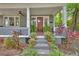 Charming front porch with red door, ceiling fan, and potted plants at 427 E Church St, Deland, FL 32724