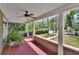 View of a front porch featuring a ceiling fan, painted floor, and a view of the front yard at 427 E Church St, Deland, FL 32724