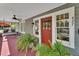 A welcoming front porch with a swing, ferns, and a view of the street with number 427 at 427 E Church St, Deland, FL 32724