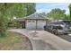 Two-car garage with a covered area and a long driveway at 427 E Church St, Deland, FL 32724