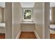 Hallway with built in storage between two bedrooms offers additional storage space and natural light from the window at 427 E Church St, Deland, FL 32724