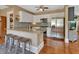 Stylish kitchen featuring white cabinets, stainless steel appliances, granite countertops, and island seating at 427 E Church St, Deland, FL 32724