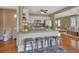 Bright kitchen with white cabinets, granite countertops, stainless steel appliances, and an eat-in island at 427 E Church St, Deland, FL 32724