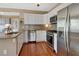 Updated kitchen featuring stainless steel appliances, granite countertops, and white cabinetry at 427 E Church St, Deland, FL 32724