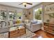 Comfortable living room featuring a large sectional sofa, hardwood floors, and large windows at 427 E Church St, Deland, FL 32724