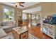 Open-concept living room featuring hardwood floors, a ceiling fan, and a kitchen/dining room view at 427 E Church St, Deland, FL 32724