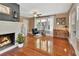 Cozy living room features hardwood floors, fireplace, and large windows with natural light at 427 E Church St, Deland, FL 32724