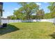 Spacious backyard with a well-maintained lawn, and a sturdy white fence at 4333 Arch St, Orlando, FL 32808