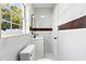 Modern bathroom featuring marble walls and black fixtures at 4333 Arch St, Orlando, FL 32808