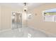 Bedroom with natural light, modern flooring, mirrored closet doors and stylish chandelier at 4333 Arch St, Orlando, FL 32808