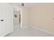 Bedroom featuring neutral paint, luxury floors, chandelier, and open door to another room at 4333 Arch St, Orlando, FL 32808