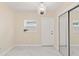 Bright bedroom featuring a decorative chandelier, luxury flooring, window and mirrored closet at 4333 Arch St, Orlando, FL 32808