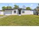 Well-maintained home featuring a freshly painted exterior, green grass, and black trim at 4333 Arch St, Orlando, FL 32808