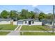 Exterior view of a modern single-Gathering home with a well-kept lawn, enhancing curb appeal and charm at 4333 Arch St, Orlando, FL 32808