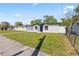 Home exterior with modern white paint, dark trim, and a well-manicured lawn at 4333 Arch St, Orlando, FL 32808