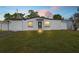 Exterior view of the home featuring a well-manicured lawn and a simple, modern architectural design at 4333 Arch St, Orlando, FL 32808