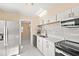 Updated kitchen featuring stainless steel appliances, white cabinets, and marble backsplash at 4333 Arch St, Orlando, FL 32808