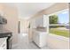 Updated kitchen with stainless appliances, white cabinets and marble tile flooring at 4333 Arch St, Orlando, FL 32808