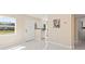 Open-concept living room with white paint, marble flooring and front door view at 4333 Arch St, Orlando, FL 32808