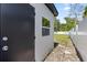 Exterior view of a shed with a white-trimmed window and a dark door at 4333 Arch St, Orlando, FL 32808