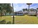 Well-maintained backyard featuring a screened porch and detached storage shed at 437 Merrimac Dr, Port Orange, FL 32127