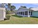 Lush backyard with a screened-in patio area and storage shed at 437 Merrimac Dr, Port Orange, FL 32127