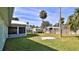 Beautiful backyard with green grass, storage shed, landscaping, and privacy fence at 437 Merrimac Dr, Port Orange, FL 32127