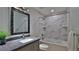 Nicely-finished bathroom featuring a marble-tiled shower-tub combination at 437 Merrimac Dr, Port Orange, FL 32127