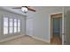 Clean, comfortable bedroom featuring tile flooring, plantation shutters, and a double closet at 437 Merrimac Dr, Port Orange, FL 32127