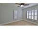 Well-lit empty bedroom with plantation shutters and tile flooring at 437 Merrimac Dr, Port Orange, FL 32127