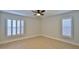 Bright, empty bedroom featuring plantation shutters and tile floors at 437 Merrimac Dr, Port Orange, FL 32127
