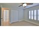 Comfortable bedroom features tile flooring, plantation shutters and a double closet at 437 Merrimac Dr, Port Orange, FL 32127