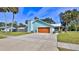 Exterior view of a blue home with a large driveway and lawn at 437 Merrimac Dr, Port Orange, FL 32127