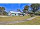 Charming home with a well-manicured lawn, sidewalk, and screened in patio at 437 Merrimac Dr, Port Orange, FL 32127