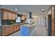 Modern kitchen with granite counters, stainless steel appliances, wood cabinets, and tiled floors at 437 Merrimac Dr, Port Orange, FL 32127