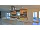 Well-appointed kitchen with stainless hood, granite countertops, tile backsplash, and ample wood cabinets at 437 Merrimac Dr, Port Orange, FL 32127