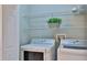 Laundry room with washer, dryer, and wire shelving at 437 Merrimac Dr, Port Orange, FL 32127