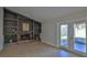 Inviting living area featuring a stone fireplace, built-in shelving, and access to the outdoors at 437 Merrimac Dr, Port Orange, FL 32127