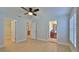 Spacious main bedroom featuring a ceiling fan, tile flooring, and views of the ensuite bathroom and walk-in closet at 437 Merrimac Dr, Port Orange, FL 32127