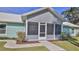 Close up of screened porch with visible house numbers and landscaping at 437 Merrimac Dr, Port Orange, FL 32127