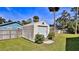Storage shed in the fenced-in backyard with a roll-up door at 437 Merrimac Dr, Port Orange, FL 32127
